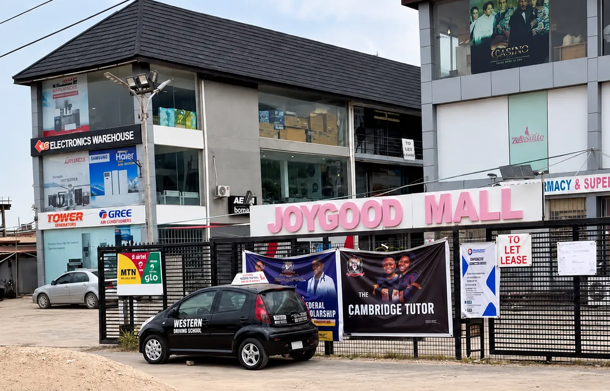 JoyGood Mall, Sangotedo, with a Western Driving School training car parked at the gate